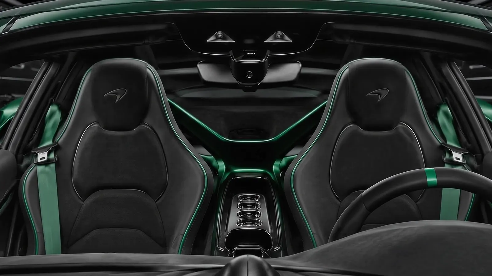 McLaren cockpit with black leather seats and green belts