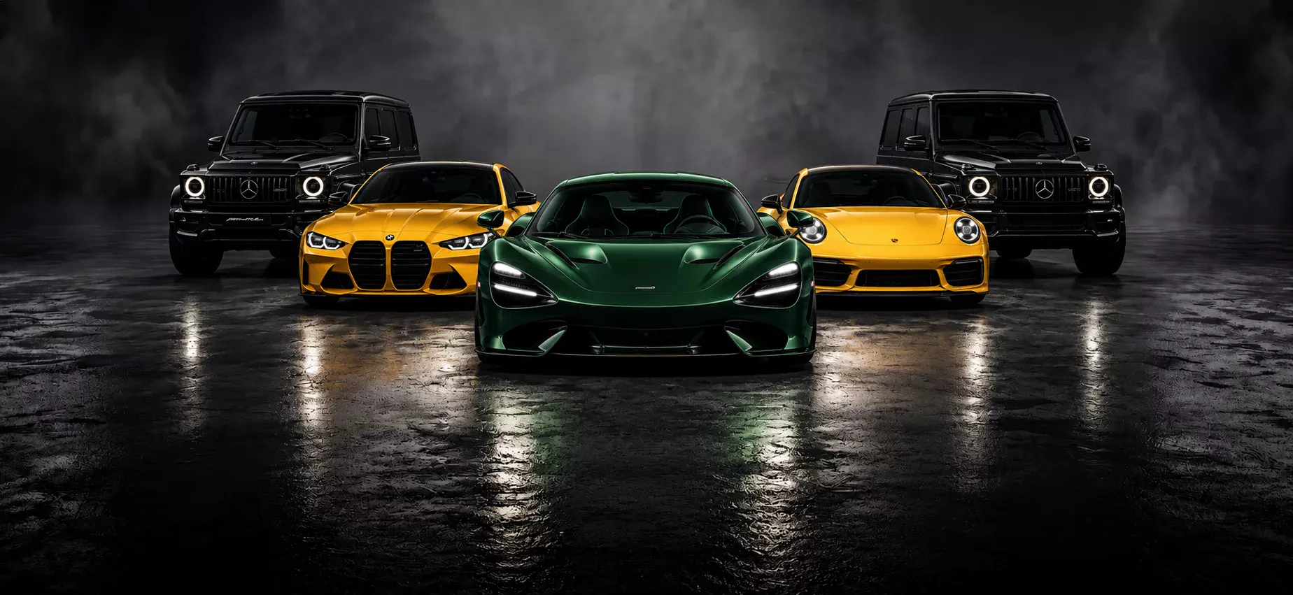 Two black G-Wagons, a yellow BMW M4, a yellow Porsche 911 and a green McLaren in a dark studio